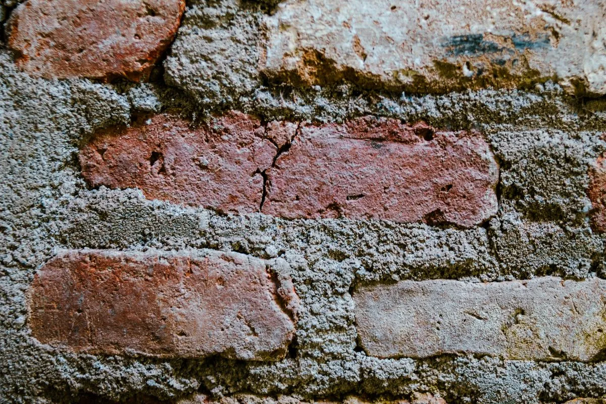 Weathered brick wall with cracked mortar joints